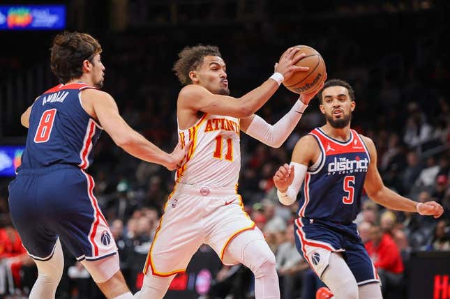 Nov 1, 2023; Atlanta, Georgia, USA; Atlanta Hawks guard Trae Young (11) drives past Washington Wizards forward Deni Avdija (8) and guard Tyus Jones (5) in the first quarter at State Farm Arena.