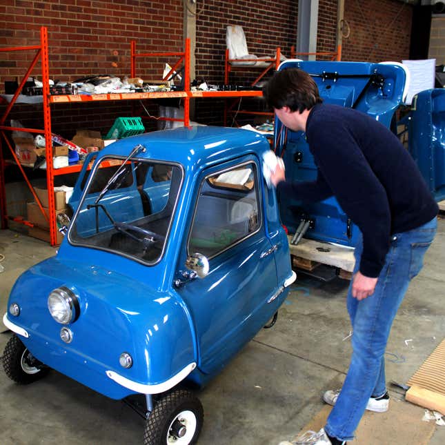 Jim Buggle of P50 Cars wipes down a replica microcar.
