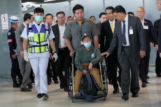 An injured Thai overseas worker, front center, who was evacuated from Israel arrives at Suvarnabhumi International Airport in Samut Prakarn Province, Thailand, Thursday, Oct. 12, 2023. The first Thai nationals evacuated since the latest war between Israel and Hamas returned home Thursday. (AP Photo/Sakchai Lalit)