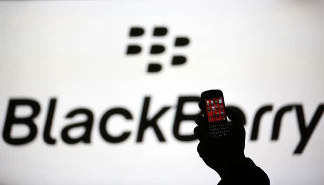 Blackberry phone in front of Blackberry logo