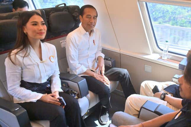 Indonesian President Joko Widodo, right, sit with Miss of Indonesia 2022 Laksmi Shari De Neefe Suardana, left, inside of high-speed railway during a test ride in Jakarta, Indonesia, Wednesday, Sept 13, 2023. Indonesia&#39;s President took a test ride Wednesday on Southeast Asia&#39;s first high-speed railway as a key project under China&#39;s Belt and Road infrastructure initiative. (Akbar Nugroho Gumay/Pool Photo via AP)