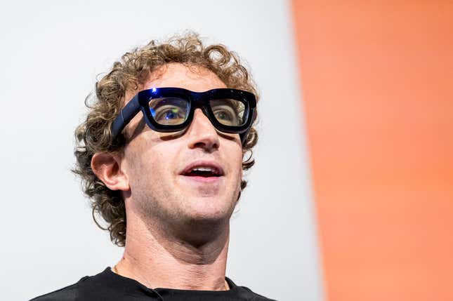 Mark Zuckerberg wearing augmented reality glasses with a thick black frame