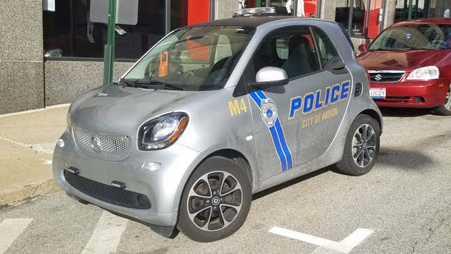 A silver second-gen smart fortwo with Akron police livery