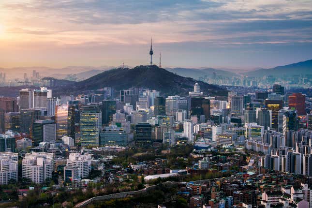 Sunrise scene of Seoul downtown city skyline, Aerial view of N Seoul Tower at Namsan Park in twilight sky in morning. The best viewpoint and trekking from inwangsan mountain in Seoul city, South Korea