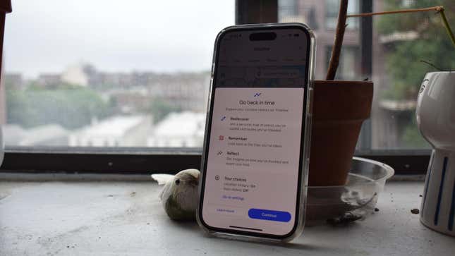 An iPhone 14 Pro showing the Google Maps Timeline feature in front of a window.