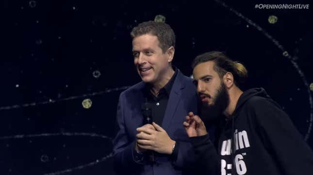 Geoff Keighley and a rogue audience member stand on stage at Games Com Opening Night. 