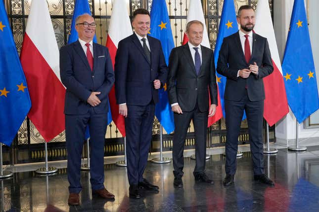 Opposition party leaders, from left, Wlodzimierz Czarzasty, Szymon Holownia, Donald Tusk and Władyslaw Kosiniak-Kamysz announce to reporters that Tusk is their candidate for prime minister and that they are ready to govern together, in Warsaw, Poland, on Tuesday Oct. 24, 2023. The parties together won a majority of seats in parliament in an election on Oct. 15. The current conservative nationalist ruling party, Law and Justice, won more votes than any other party but has no coalition partner and no apparent path to keeping power. (AP Photo/Czarek Sokolowski)