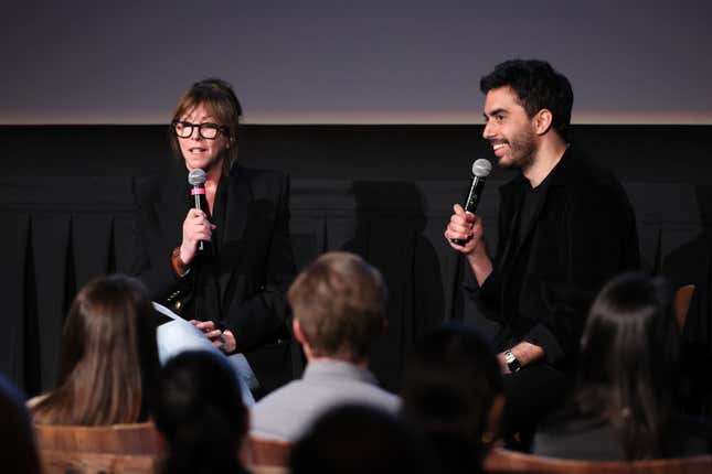 Jane Rosenthal (left) and Cristóbal Valenzuela (right) hold microphones and speak to the audience at the film festival
