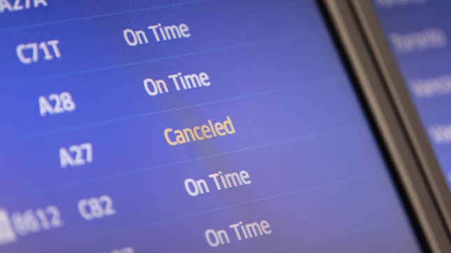 A flight board showing on time and canceled flights at Newark.