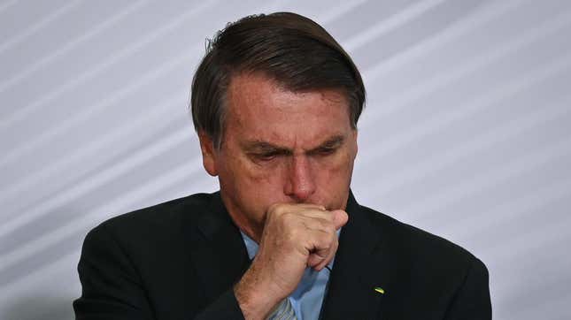 File photo showing President of Brazil Jair Bolsonaro coughing at Planalto Palace on December 9, 2020.