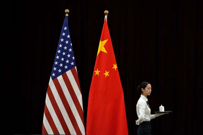 FILE - A hostess walks by the national flags of the United States and China ahead of the bilateral meeting between U.S. Treasury Secretary Janet Yellen and Chinese Vice Premier He Lifeng, at the Guangdong Zhudao Guest House in southern China&#39;s Guangdong province, April 6, 2024. Simmering tensions between Beijing and Washington remain the top worry for U.S. companies operating in China, according to a report by the American Chamber of Commerce in China released Tuesday, April 23, 2024. (AP Photo/Andy Wong, Pool, File)