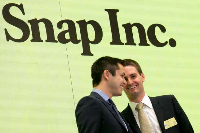 Snapchat co-founders Bobby Murphy and CEO Evan Spiegel congratulate each other after ringing the opening bell.