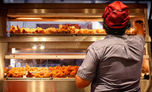 fast food employee working with chicken