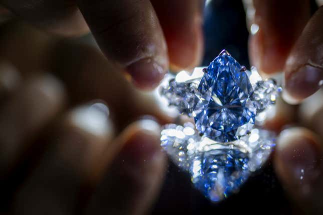 A Christie&#39;s employee displays &quot;Bleu Royal,&quot; a rare 17.61 carats internally flawless fancy vivid blue pear shaped diamond, during a preview at the Christie&#39;s, in Geneva, Switzerland, Thursday, Nov. 2, 2023. The “Bleu Royal” sold at auction Tuesday, Nov. 7, for more than $44 million, far outstripping the pre-sale estimate, Christie&#39;s said. (Martial Trezzini/Keystone via AP)