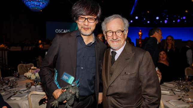 Takashi Yamazaki poses with a fan at the 2024 Oscars Nominees Luncheon