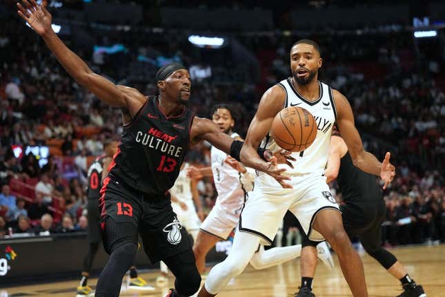 Nov 16, 2023; Miami, Florida, USA; Miami Heat center Bam Adebayo (13) tips the ball away from Brooklyn Nets forward Mikal Bridges (1) in the second half at Kaseya Center.