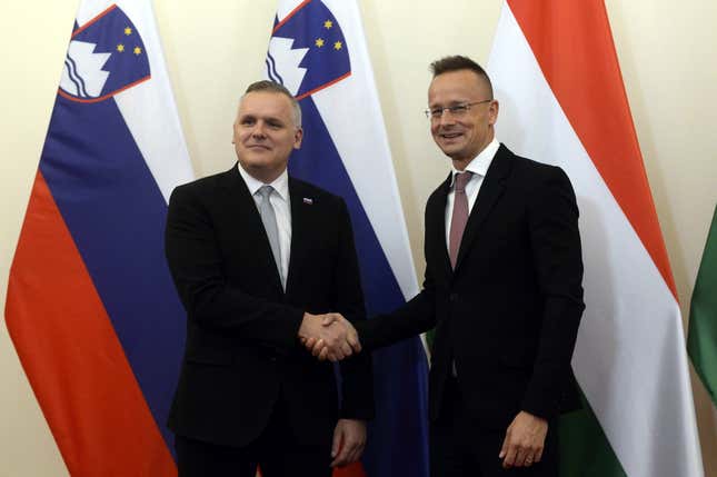 Slovenian Minister for the Environment, Climate and Energy, Bojan Kumer, left, is welcomed by Hungarian Minister of Foreign Affairs and Trade Peter Szijjarto, right, for a meeting in Budapest, Hungary, Wednesday, Oct. 4, 2023. (Attila Kovacs/MTI via AP)