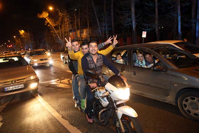 Celebrants ride through the streets of Tehran April 2.