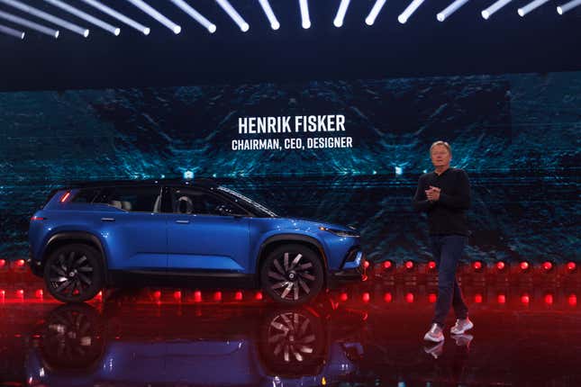 Fisker CEO Henry FIsker stands next to the all-electric Ocean SUV. The EV has been the subject of over 100 complaints filed with U.S. federal regulators.