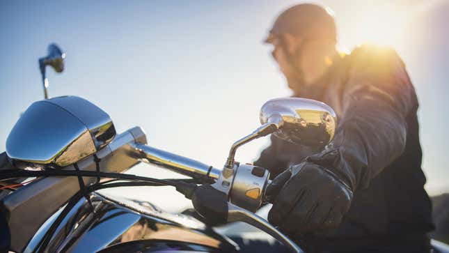 Close up shot of motorcyclist on sunset.