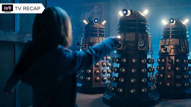 The Doctor waves her sonic screwdriver at three approaching Daleks.