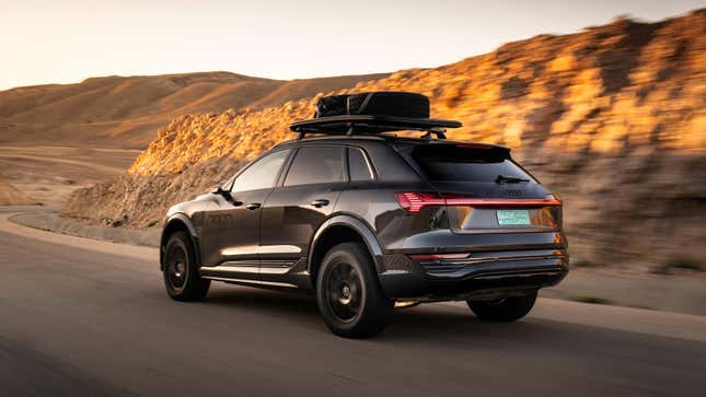 Rear 3/4 view of a black Audi Q8 E-Tron driving in the desert