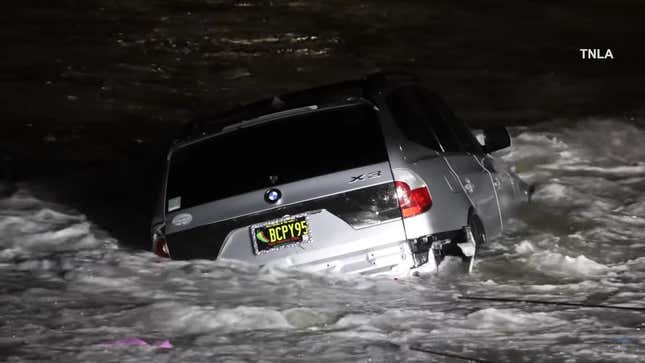 A photo of a BMW SUV crashed into the sea. 