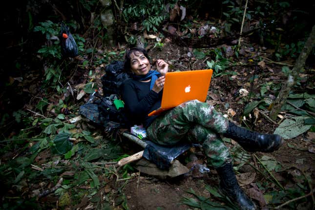 A FARC mid-level commander works on her computer at a hidden camp in the northwest Andes of Colombia.