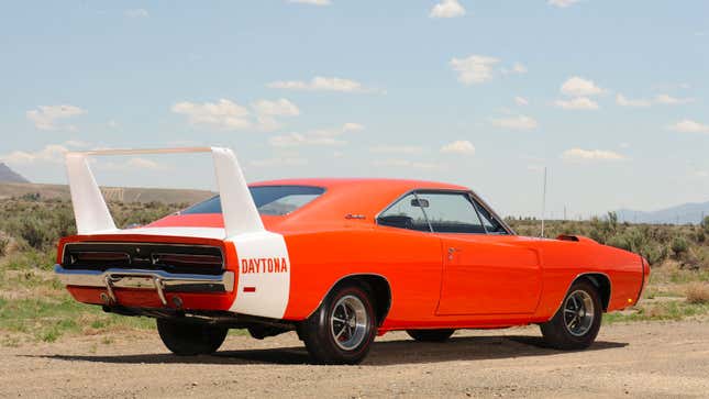 A photo of an orange Dodge Charger Daytona. 