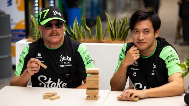 Valtteri Bottas of Finland and Stake F1 Team Kick Sauber plays jenga with his teammate Zhou Guanyu of China and Kick Sauber in the paddock during previews ahead of the F1 Grand Prix of Brazil at Autodromo Jose Carlos Pace on October 31, 2024 in Sao Paulo, Brazil.