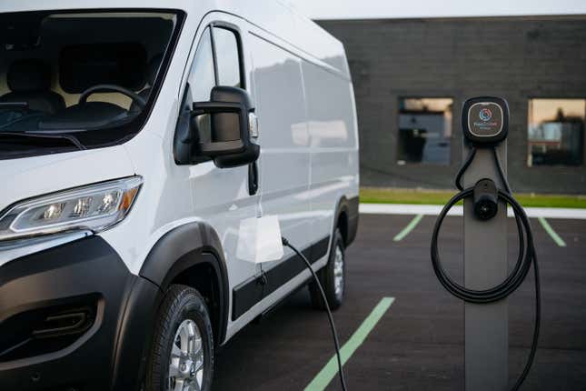 A Ram ProMaster EV van plugged into a charging station