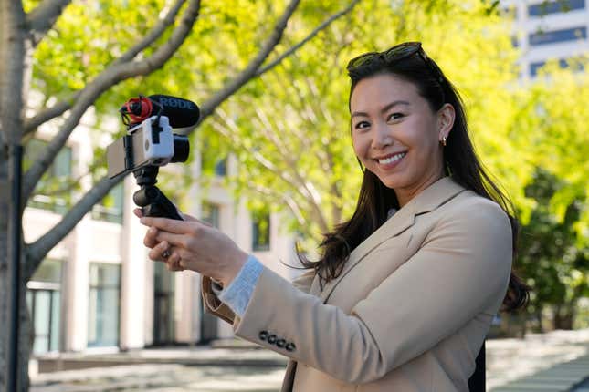 Content creator Cynthia Huang Wang poses near the Embarcadero in San Francisco, Monday, April 8, 2024. Despite a strong job market, there are still thousands of people who have found themselves out of work across industries stretching from tech to retail to media. But rather than trying to find another job in their old role, some workers are turning to online content creation. (AP Photo/Eric Risberg)