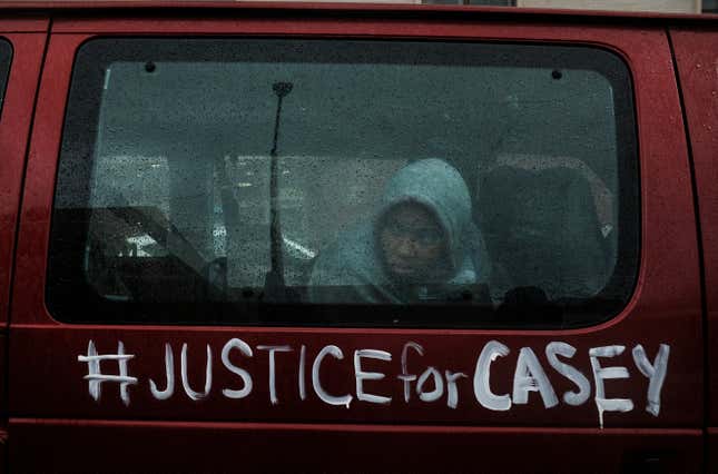 A protester riding in a van watches as hundreds of protesters march through downtown Columbus on December 12, 2020 in Columbus, Ohio. Goodson’s family and those close to him spoke in front of the Ohio State House to a crowd of several hundred protesters. The group then marched through the streets of Columbus.