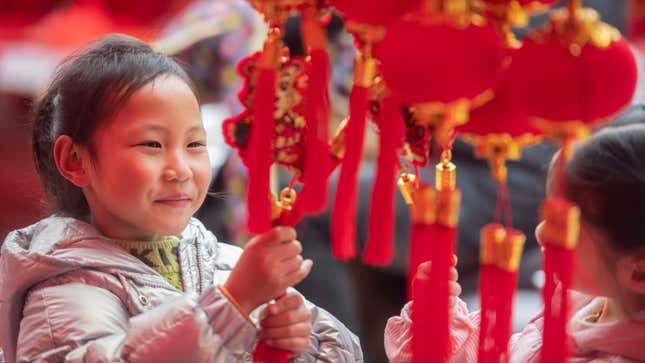 Children light fire crackers to celebrate Chinese New Year China