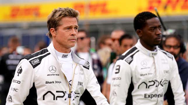 A photo of Brad Pitt and Damson Idris in race suits. 
