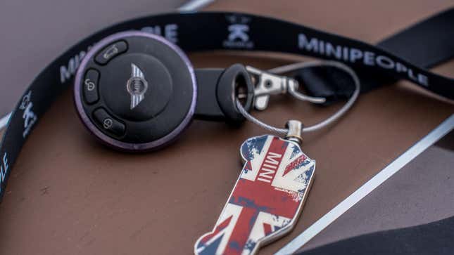 A Mini Cooper key on a Mini lanyard with a Mini keychain on it