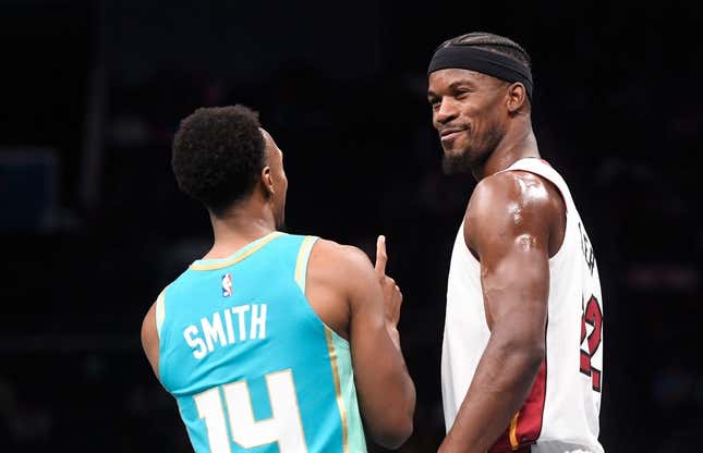 Nov 14, 2023; Charlotte, North Carolina, USA;  Miami Heat forward Jimmy Butler (22) talks to Charlotte Hornets guard Ish Smith (14) during a time out during the first half at the Spectrum Center.