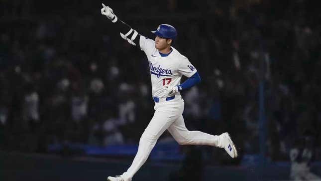 Shohei Ohtani points his finger up to the crowd as he runs