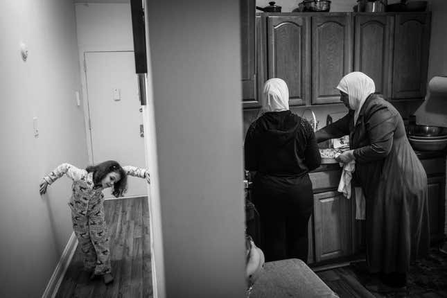 Souad, 6, plays in the hallway of her family’s two bedroom apartment in Brooklyn while her mother and grandmother cook dinner for the family.