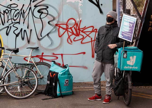 FILE -Gig economy riders for app-based meal delivery platform Deliveroo demonstrate near the company headquarters in London, Wednesday, April 7, 2021. In a bid to improve working conditions for people who deliver food and offer rides through smartphone apps, the European Union gave provisional approval Wednesday, Dec. 13, 2023, to rules that determine who should get the benefits of full-time employees and restrict the way online platforms use algorithms to manage their workers. (AP Photo/Alastair Grant, File)