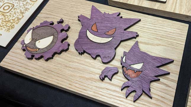 Pokemon are positioned on wooden art.
