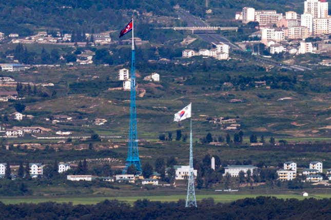 FILE - Flags of North Korea, rear, and South Korea, front, flutter in the wind as pictured from the border area between two Koreas in Paju, South Korea, on Aug. 9, 2021. South Korea said Monday, Nov. 6, 2023, it plans to launch its first domestically built spy satellite at the end of this month as part of its efforts to better monitor rival North Korea and deter its potential aggressions.(Im Byung-shik/Yonhap via AP, File)