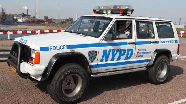 A white and blue NYPD police Jeep Cherokee