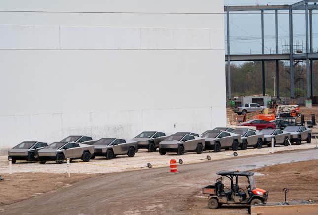Newly manufactured Tesla Cybertrucks are parked outside the company's Giga Texas factory on December 13, 2023, in Austin, Texas