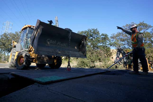 A Pacific Gas and Electric crew works on burying power lines in Vacaville, Calif., Wednesday, Oct. 11, 2023. PG&amp;E wants to bury many of its power lines in areas threatened by wildfires. (AP Photo/Jeff Chiu)