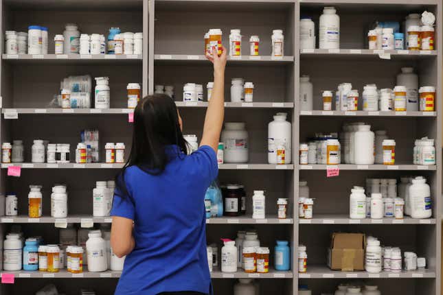 A pharmacy technician grabs a bottle of drugs off a shelve at the central pharmacy of Intermountain Heathcare on September 10, 2018 in Midvale, Utah. 