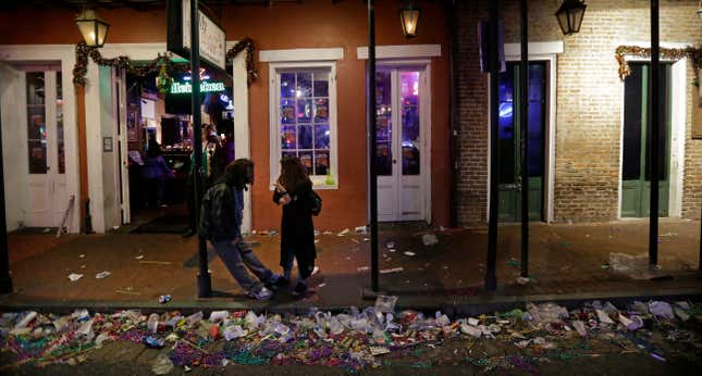 FILE - Trash lines the gutter on Bourbon Street, in the early hours of the morning after Mardi Gras, in New Orleans, Feb. 18, 2015. It’s a beloved century-old Carnival season tradition in New Orleans — masked riders on lavish floats fling strings of colorful beads or other trinkets to parade watchers clamoring with outstretched arms. It&#39;s all in good fun but it&#39;s also a bit of a “plastics disaster,” says Judith Enck, a former Environmental Protection Agency regional administrator and president of the advocacy group Beyond Plastics. (AP Photo/Gerald Herbert, file)