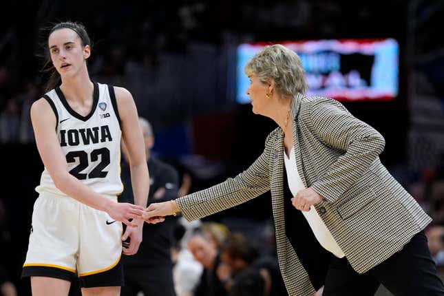 Iowa guard Caitlin Clark (22) reacts with head coach Lisa Bluder during the second half of a Final Four college basketball game against UConn in the women&#39;s NCAA Tournament, Friday, April 5, 2024, in Cleveland. (AP Photo/Morry Gash)