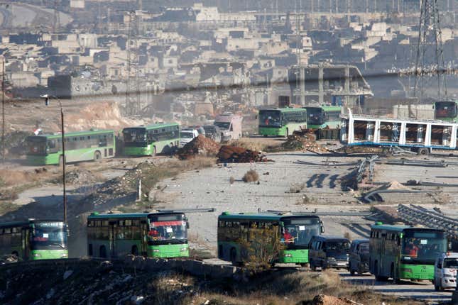 Evacuation ambulances and buses drive out of a rebel-held part of Aleppo, Syria December 15, 2016. (Reuters/Omar Sanadiki)