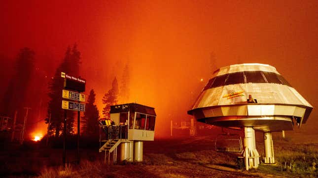 A ski lift at Sierra-at-Tahoe Resort with flames in the background.